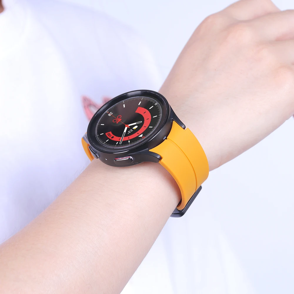 Orange silicone strap for Samsung Galaxy Watch 4/5/6 with a matte black buckle and band loop, showcasing a smooth finish and a tapering design with holes for adjustable fit and comfort